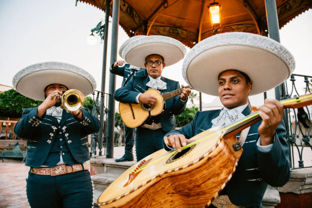 Mariachi Band Playing Mariachi Band Playing under Mexican Kiosk bass instrument stock pictures, royalty-free photos & images