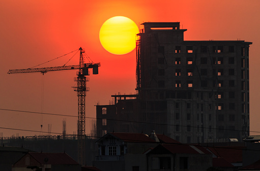 A building in progress during the sunset