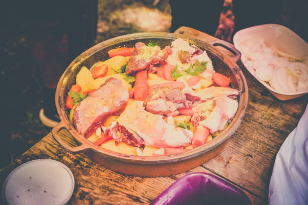 istock Fresh meat with vegetables prepared for baking, on a wooden table 1156998000