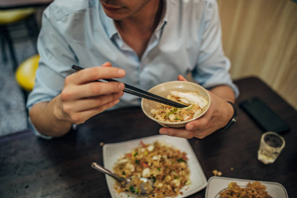 istock Man eating Taiwanese food 1157003325