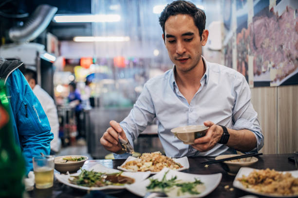 istock Man eating Taiwanese food 1157003413