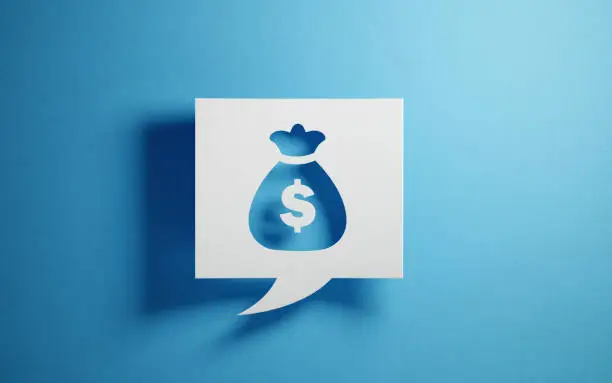 Photo of White Chat Bubble With A Money Pouch On Blue Background