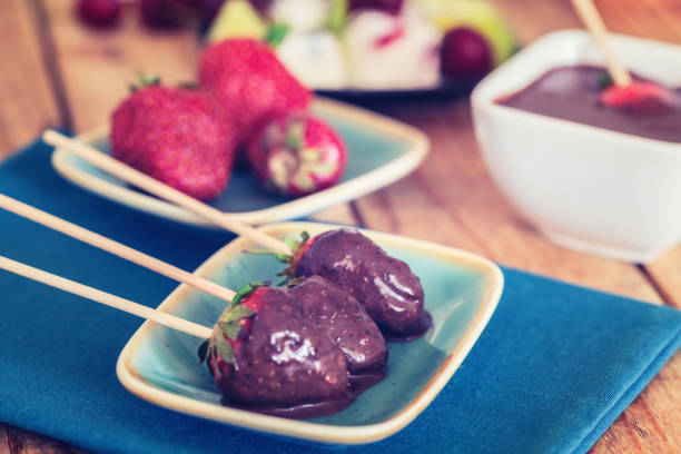 istock Cold strawberries coated with melted chocolate, close-up 1157007629