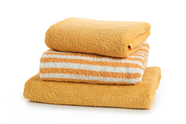 istock A stack of towels yellow  on a white background 1157007871