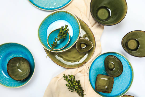 istock Simple rustic handmade blue crockery against white wooden wall: dish, stack of bowls. 1157008027