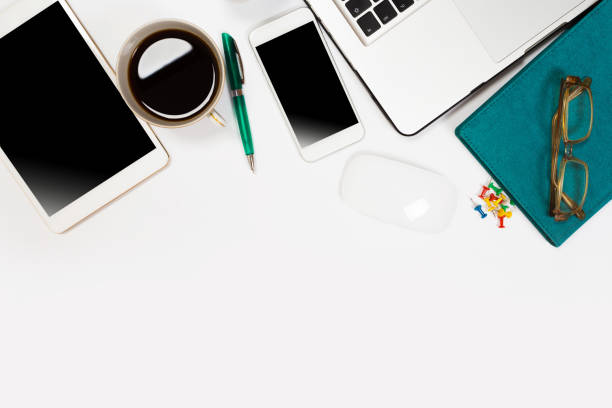 istock Modern workspace with coffee cup, smartphone, paper, notebook, tablet and laptop copy space on white color background. Top view. Flat lay style. 1157008158