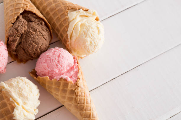istock Strawberry, Vanilla, and Chocolate Ice Cream in Waffle Cones 1157008228