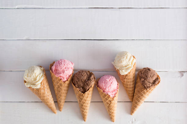 istock Strawberry, Vanilla, and Chocolate Ice Cream in Waffle Cones 1157008758