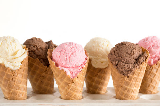 istock Strawberry, Vanilla, and Chocolate Ice Cream in Waffle Cones 1157008759