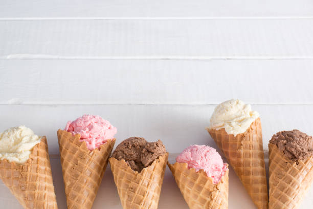 istock Strawberry, Vanilla, and Chocolate Ice Cream in Waffle Cones 1157008857
