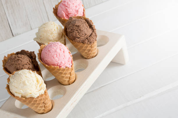 istock Strawberry, Vanilla, and Chocolate Ice Cream in Waffle Cones 1157008884
