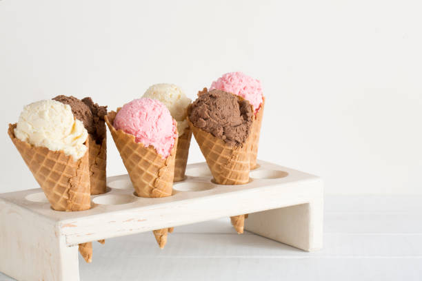 istock Strawberry, Vanilla, and Chocolate Ice Cream in Waffle Cones 1157009059