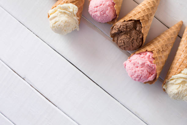 istock Strawberry, Vanilla, and Chocolate Ice Cream in Waffle Cones 1157009063
