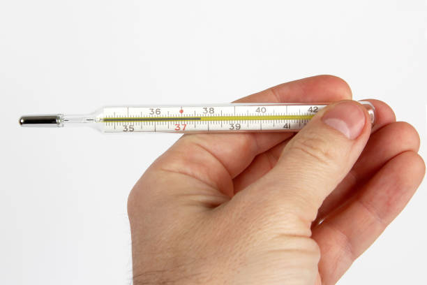 istock hand with medical thermometer close up 1157009199
