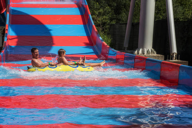 istock Happy father and son after ride down at amusement water park 1157010022