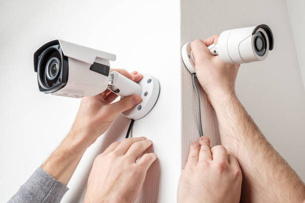 istock CCTV Concept. Workers installing video surveillance cameras on walls 1157010362