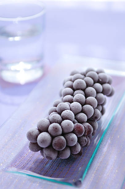 Frozen Grape Fozen Grape on Square Plate frozen grapes stock pictures, royalty-free photos & images