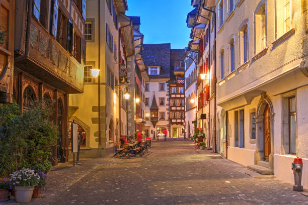 Street in old town of Zug, Switzerland Night scene of a street in old town of Zug, Switzerland. swiss culture photos stock pictures, royalty-free photos & images