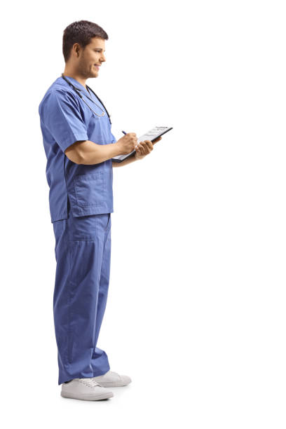 istock Male doctor in a blue uniform writing on a clipboard 1157015392