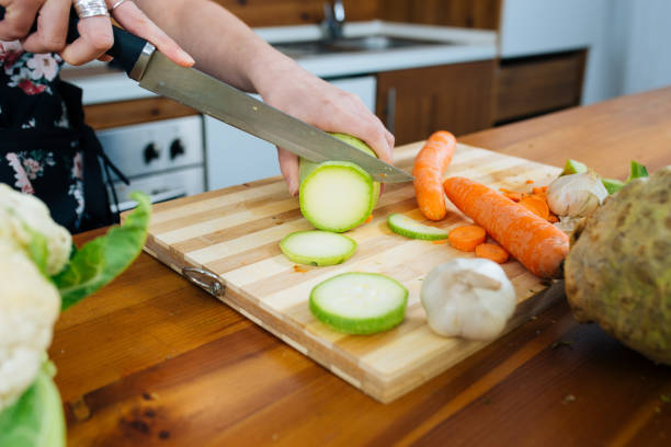 istock Woman in the Kitchen Chopping Some Veggies 1157015577