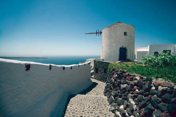 istock Cobbled Step Street And Old Windmill In Santorini, Greece 1157017038