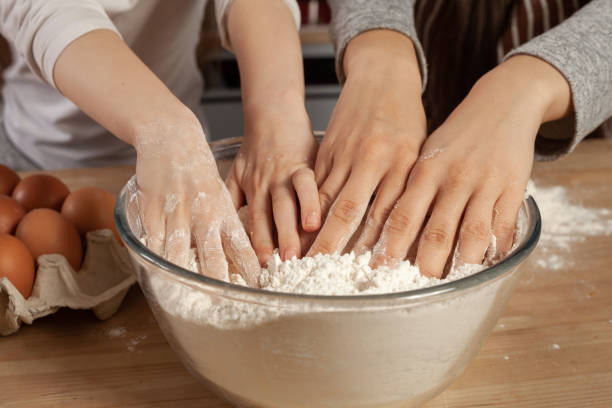 istock Mother and her daughter are baking a bread and having fun at the kitchen 1157017245