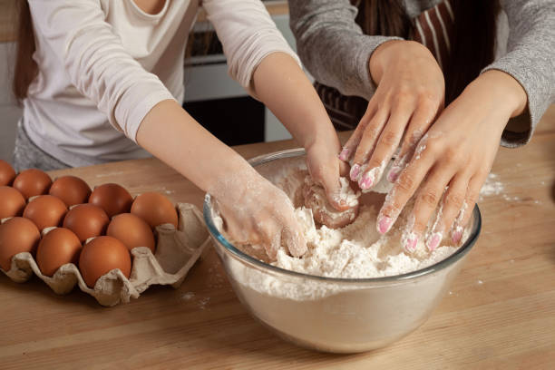 istock Mother and her daughter are baking a bread and having fun at the kitchen 1157017253