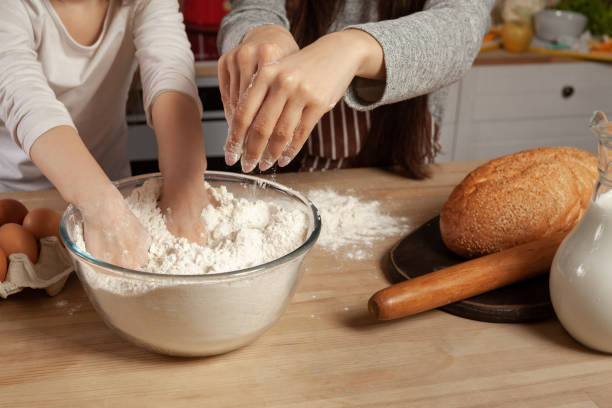 istock Mother and her daughter are baking a bread and having fun at the kitchen 1157017281