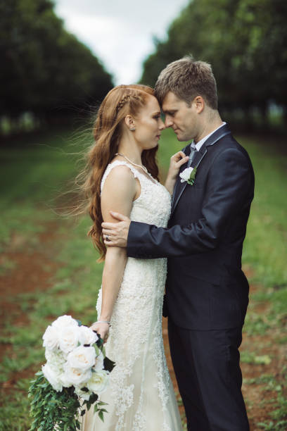 istock Wedding Couple Embracing in Rural Orchard 1157017453