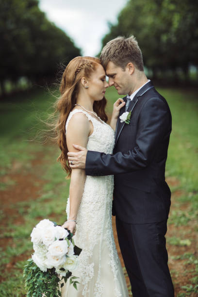 istock Wedding Couple Embracing in Rural Orchard 1157017494