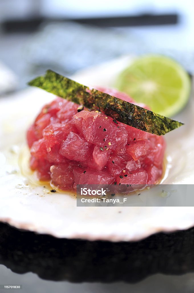 Maguro Tataki Close-up Maguro Tataki (or Tuna Tartare) Garnished with Nori Served in Shell Tataki Stock Photo