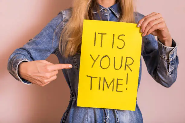 Photo of Woman holding paper with text it is your time