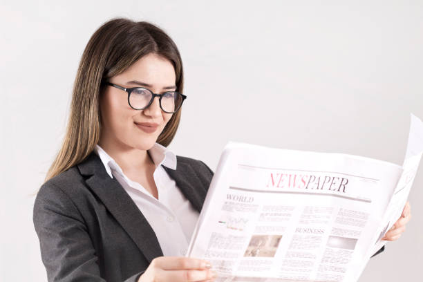 istock Woman reading the newspaper on wall 1157019820