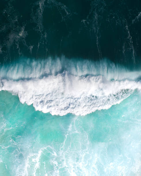 Top view of the ocean and a massive wave crashing. Storm wave breaking in the sea, ocean Top view of the ocean and a massive wave crashing. Storm wave breaking in the sea, ocean in Australia bondi beach sunrise stock pictures, royalty-free photos & images