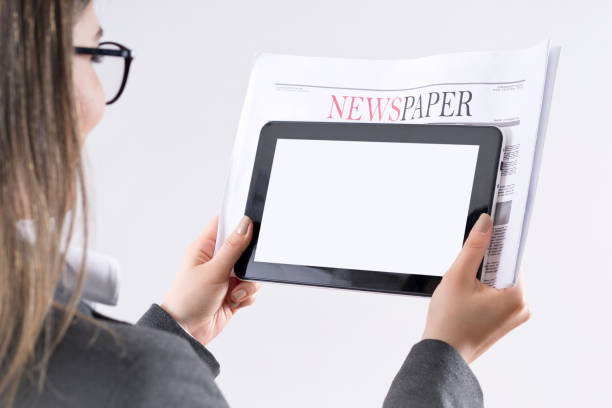 istock Woman reading daily news and empty tablet 1157020264