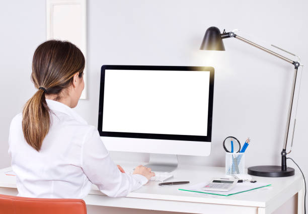 istock Close-up Of A Businesswoman Using Computer With Blank Screen At Workplace 1157020727