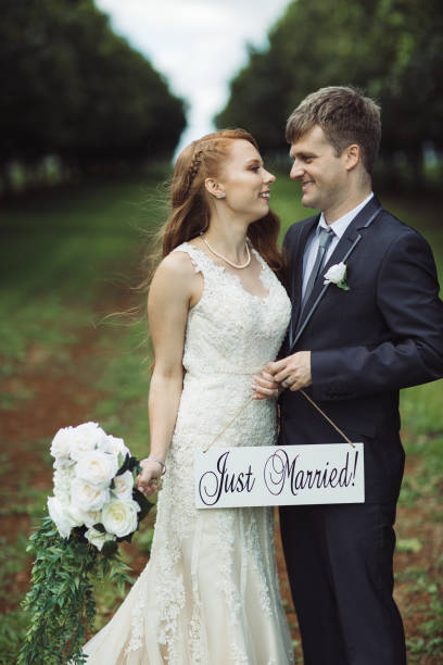 istock Couple Holding Just Married Sign 1157021621