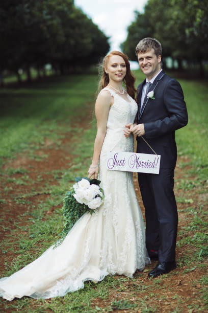 istock Couple Holding Just Married Sign 1157022322