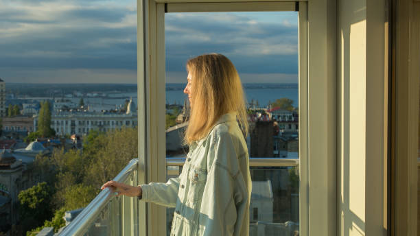 istock young woman on the balcony 1157024520