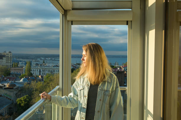 istock young woman on the balcony 1157024799