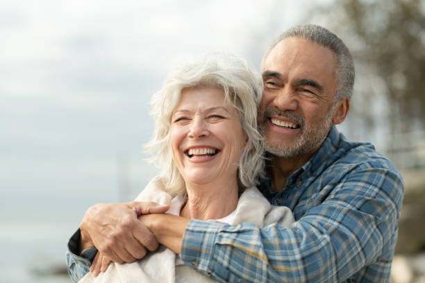 istock Laughing senior couple on a beach 1157025549