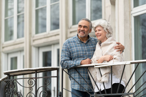 istock Cuddling interracial couple standing on a balcony 1157025559