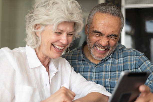 istock Senior couple using electronic tablet to video chat 1157025659