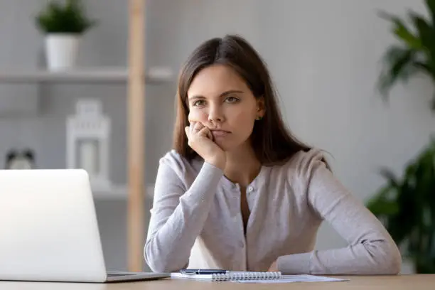 Photo of Tired young woman feel bored working at laptop