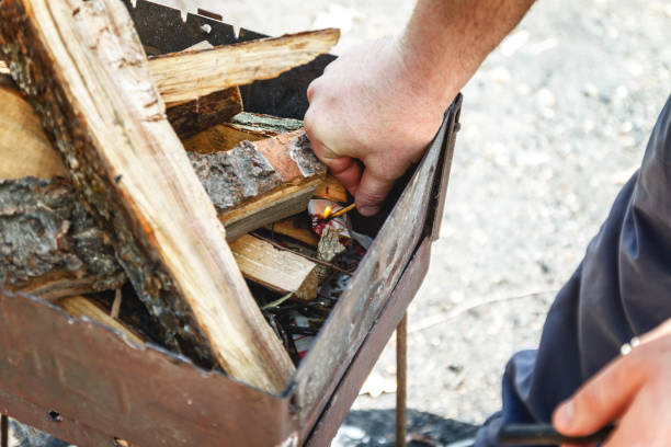 istock A man kindles a fire in a brazier with matches 1157026168