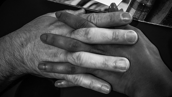 Black and white photo of holding hands