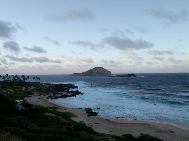 istock Ocean waves lap on Makapuu beach at dusk 1157036588