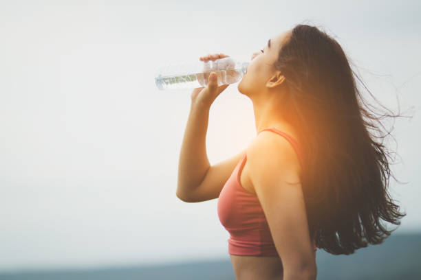 istock Asia woman  drinking water after tired from exercise. 1157036812