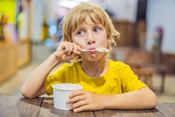 istock Boy eating ice cream in a cafe 1157039566