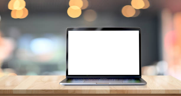 istock Laptop with blank screen on wood table. 1157041431